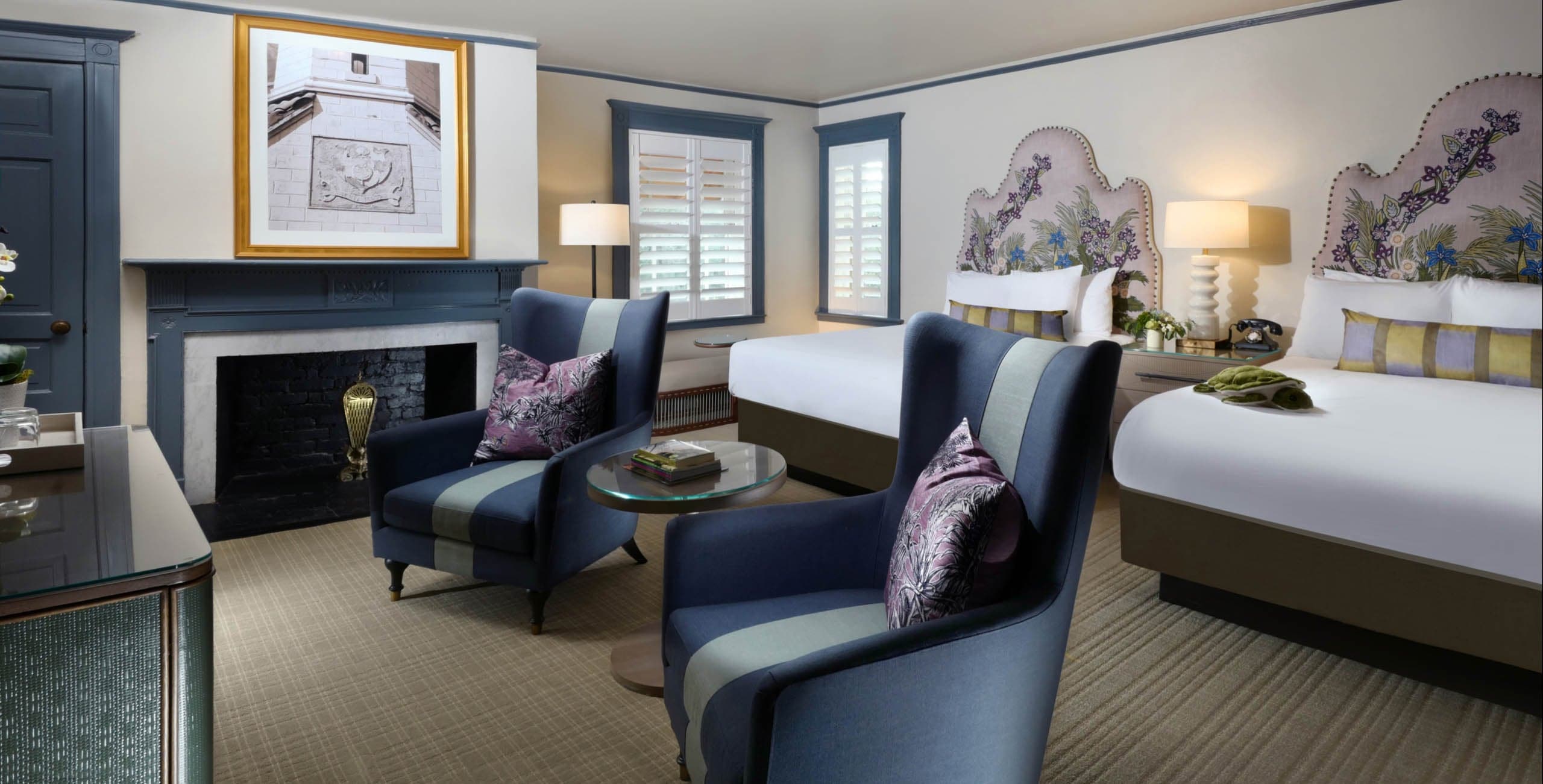 Clubhouse Traditional Two Queen with a fireplace and two lounge chairs
