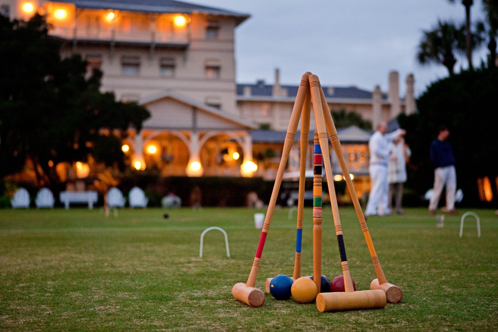 4 croquet clubs and balls stacked neatly on the grass at JIRC