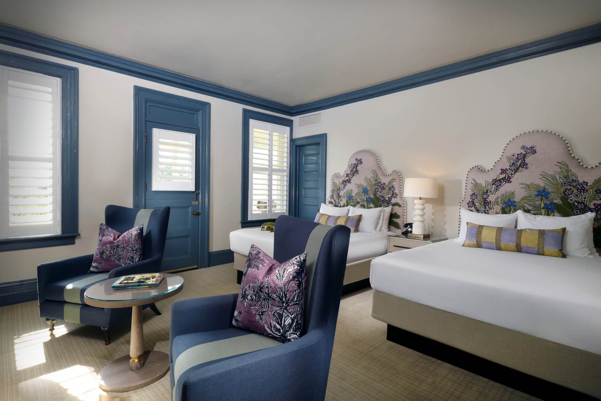Deluxe Double Queen Clubhouse room with 2 lounge chair and access to a patio