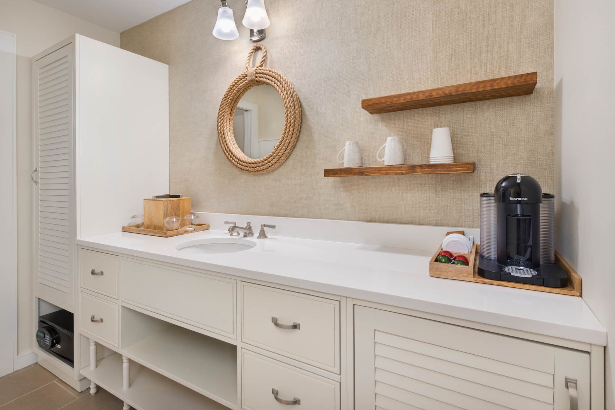 The sink area with a coffee machine, closet and safe in a room