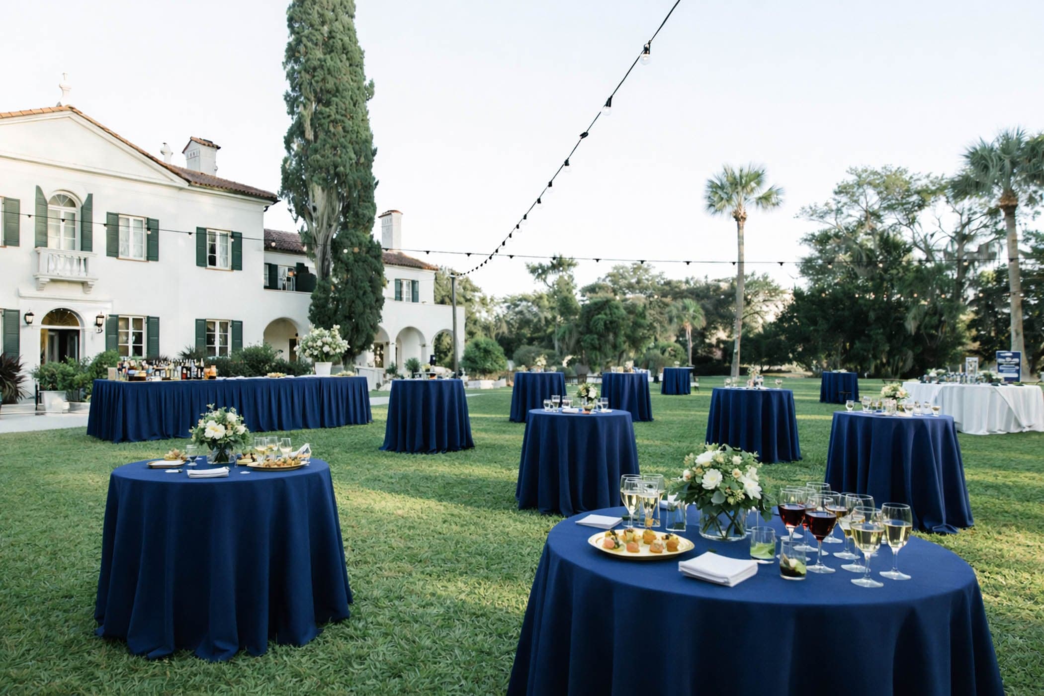 The yard of Crane set up for a function with round table set up with drinks and snacks