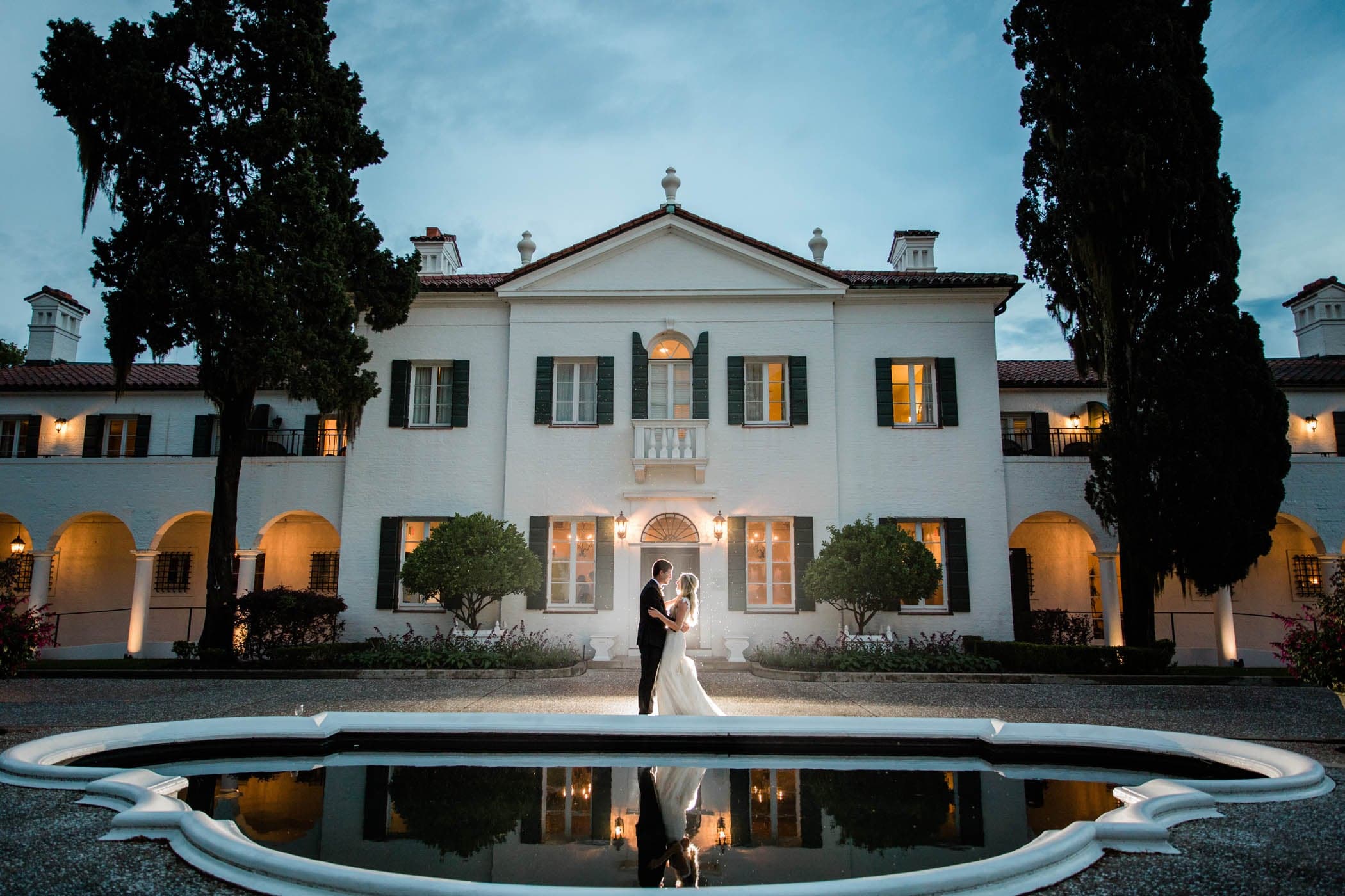 A newly wed couple embracing in front of the Island Cottages