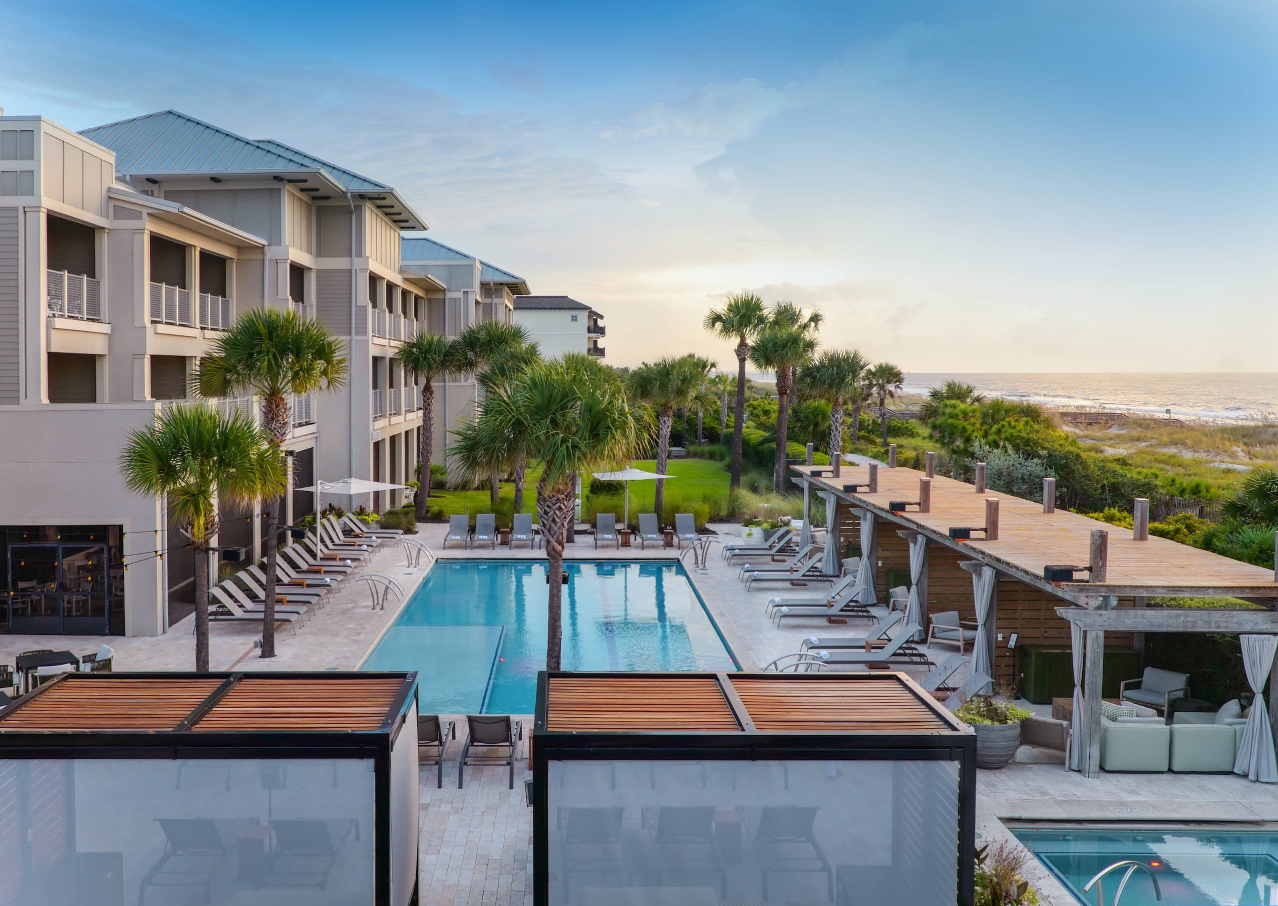 Ocean Club pool area with cabanas, lounge chairs and a view of the ocean