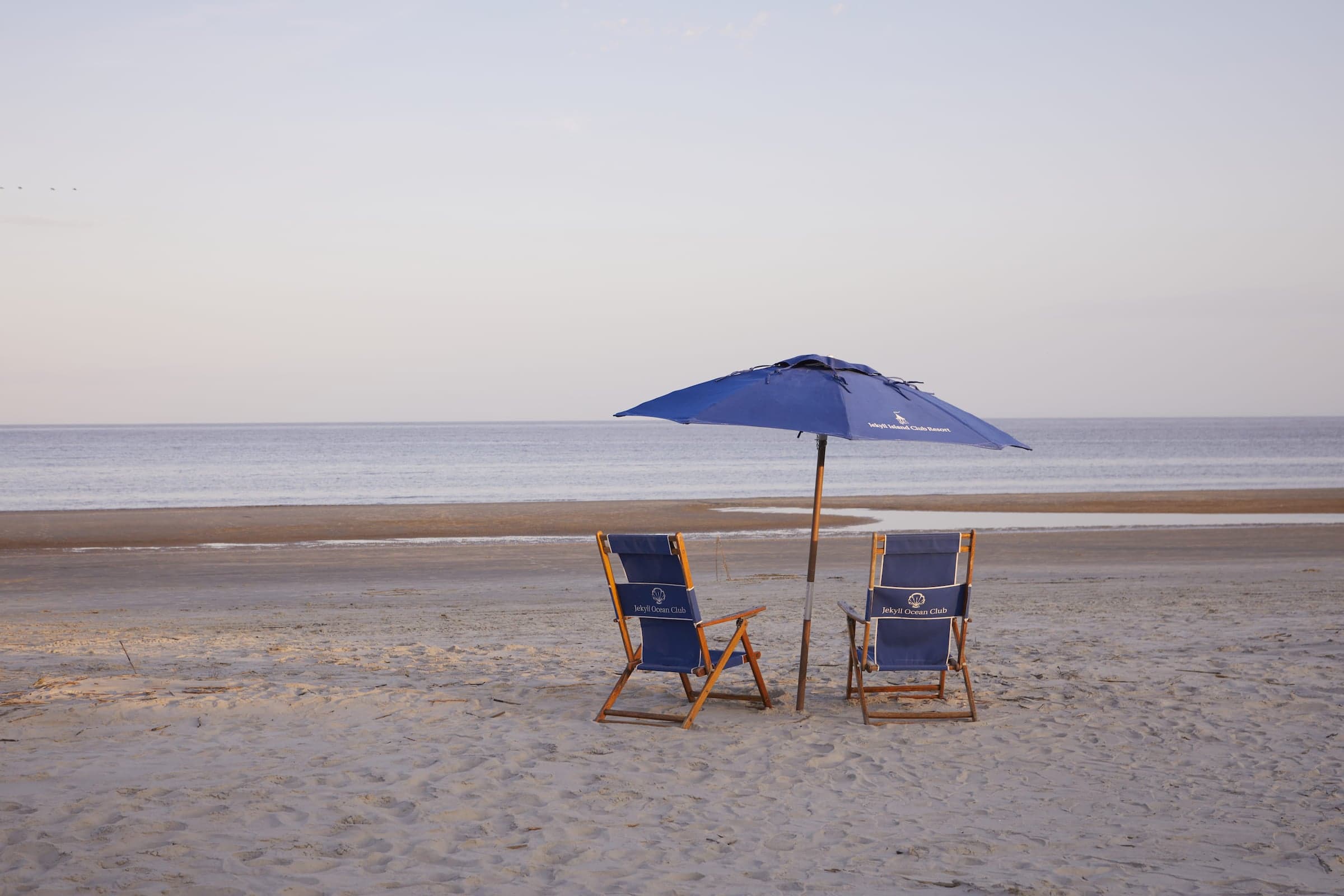 2 beach chairs and an umbrella at Jekyll Ocean Club Beach