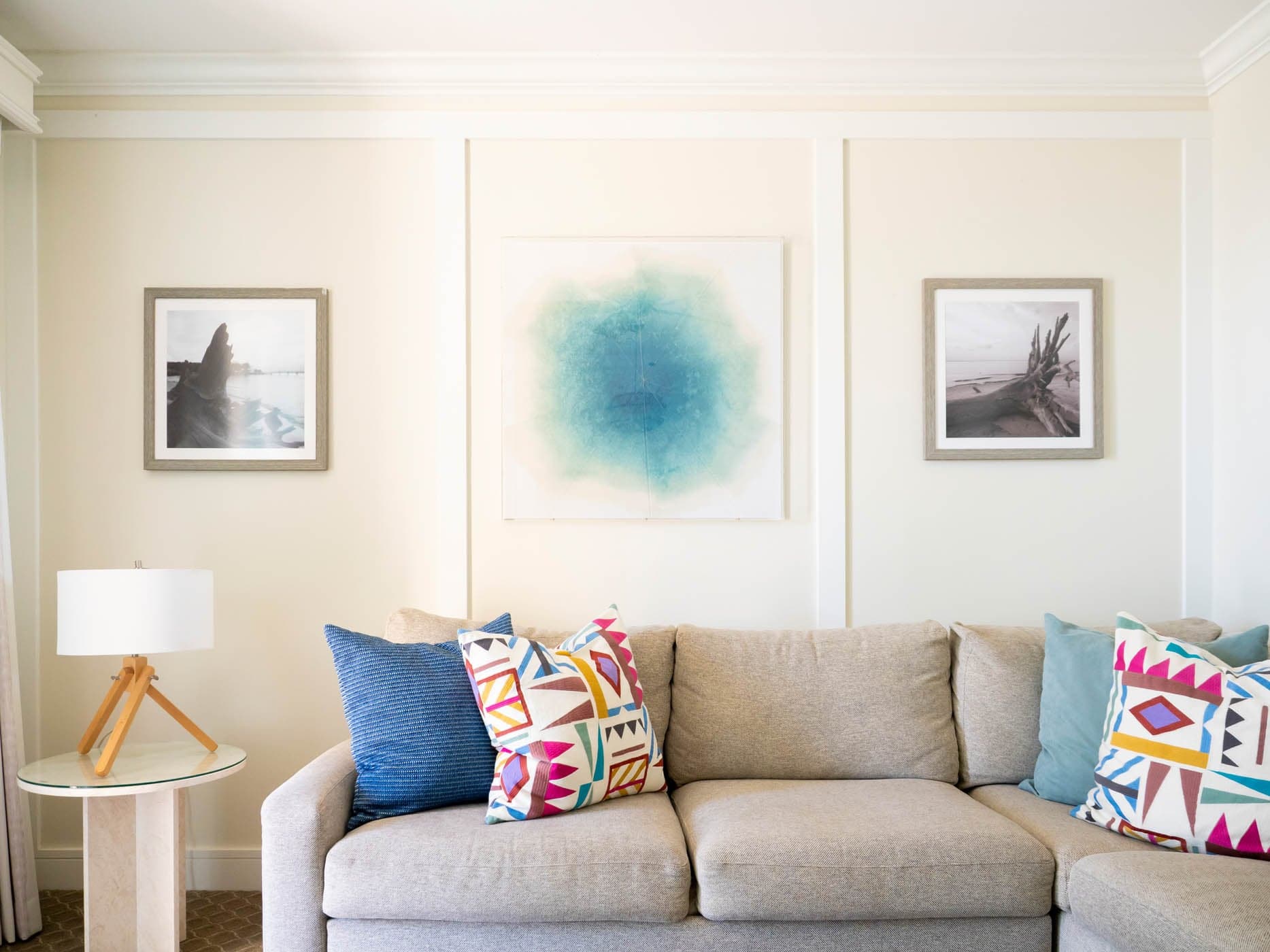 A sectional couch with wall art and a side table at Jekyll