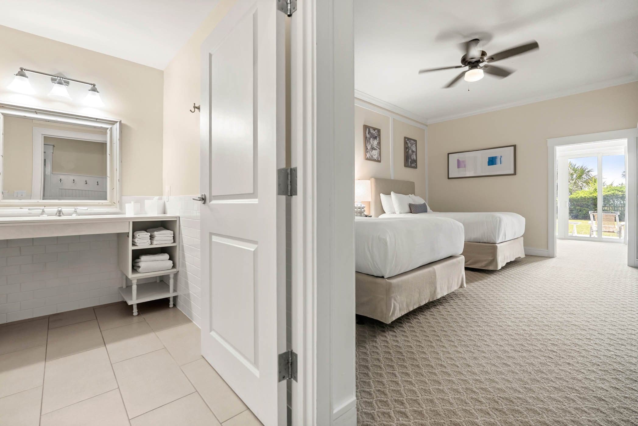 A room with 2 queen beds and access to the patio