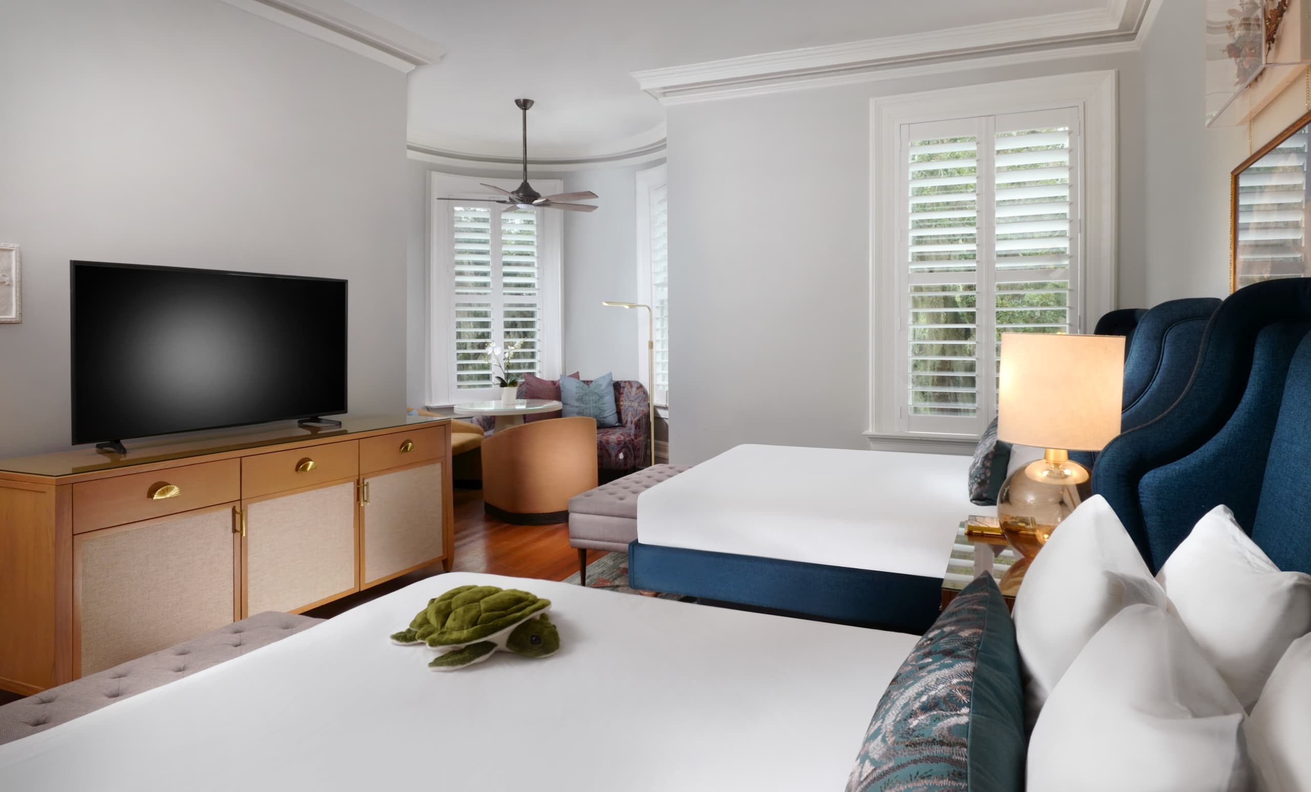 2 queen beds, ad TV and a separate living area in a San Souci Deluxe Double Queen