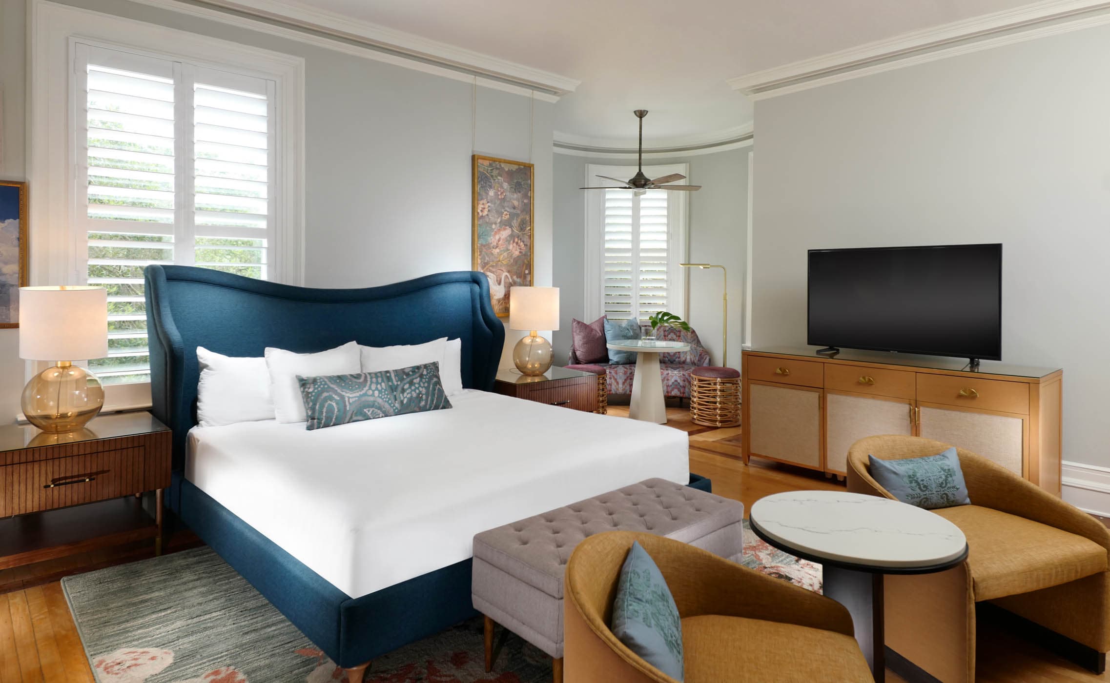 A king bed in a San Souci Deluxe King room with a TV and a sitting area