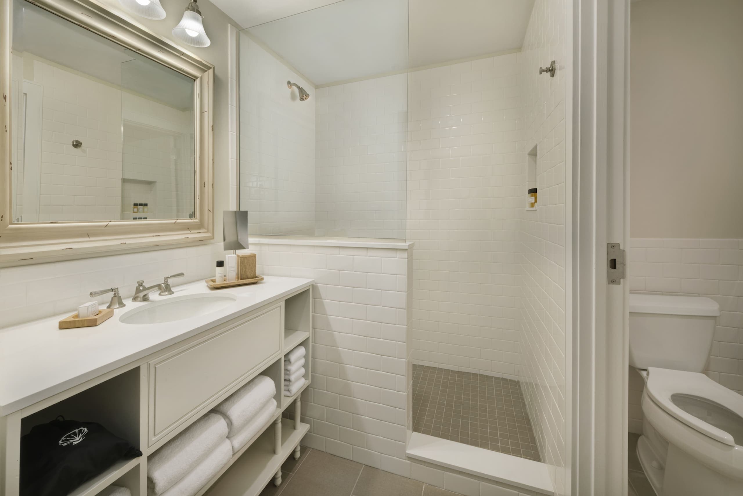 A washroom with shower, vanity and toilet