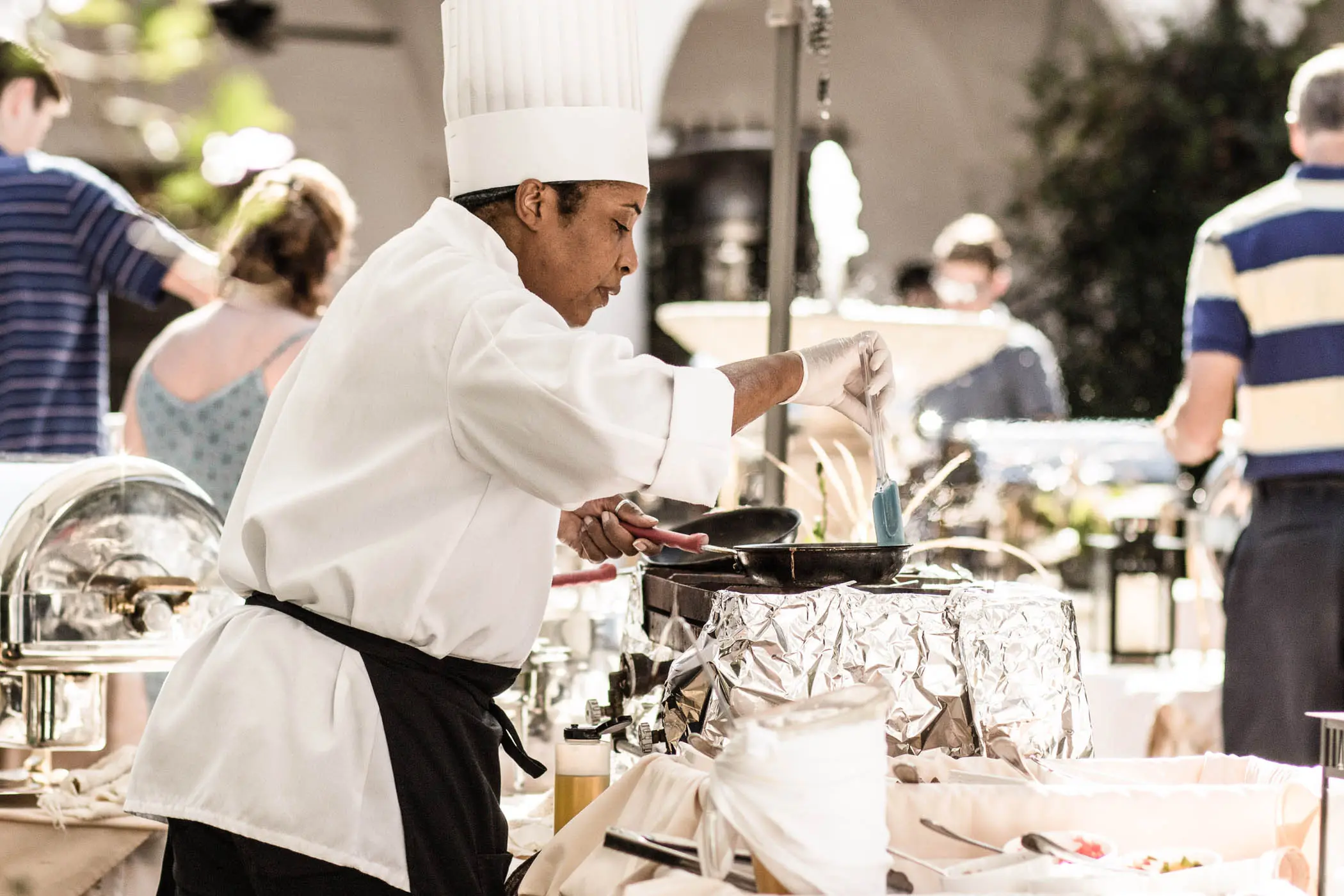 A chef preparing food at a catering event