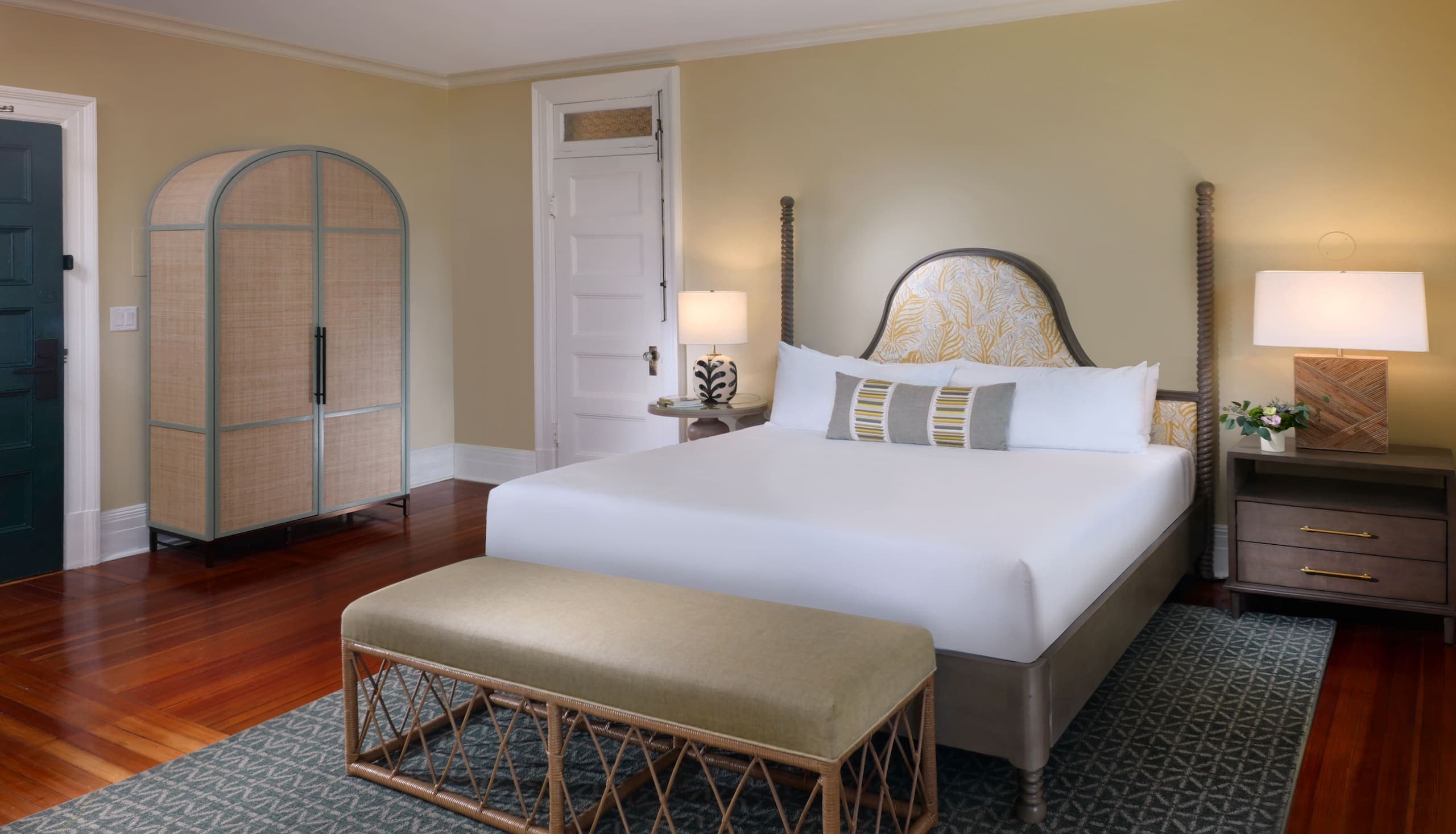 A king bed, side table and armoire in a The king bed and living area in a Cherokee Traditional King