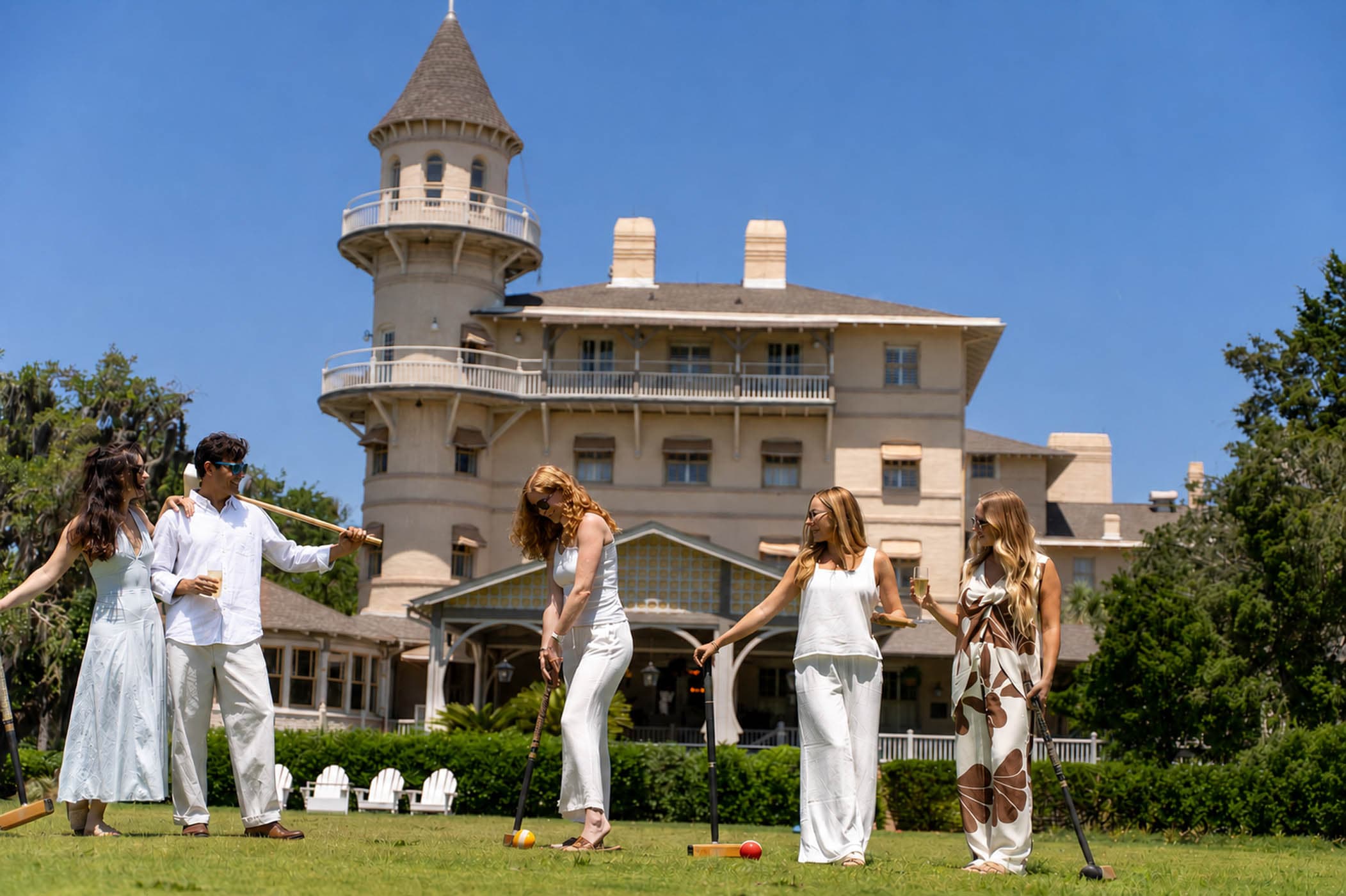 A group of people playing croquet with cocktails