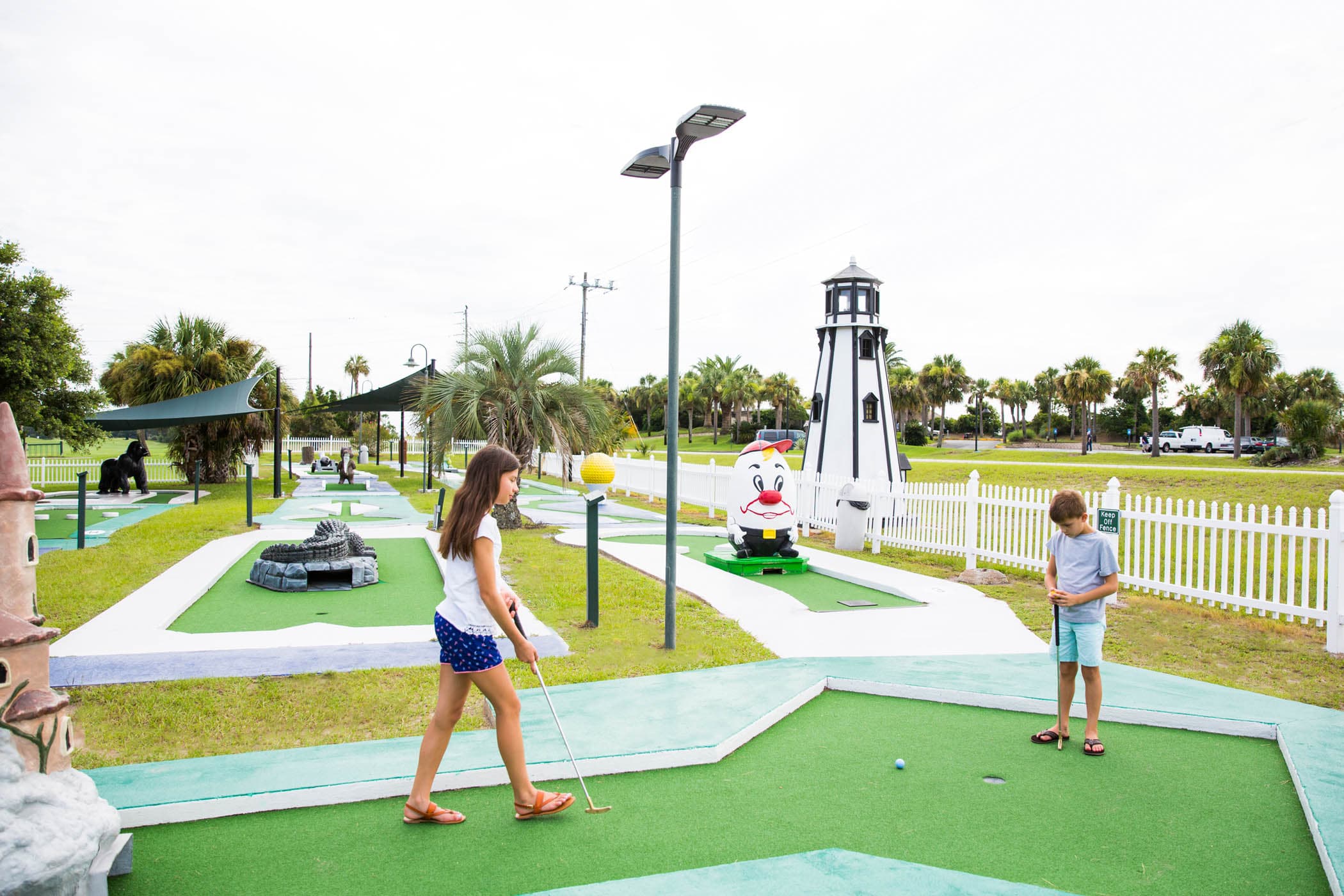 2 Children playing mini golf