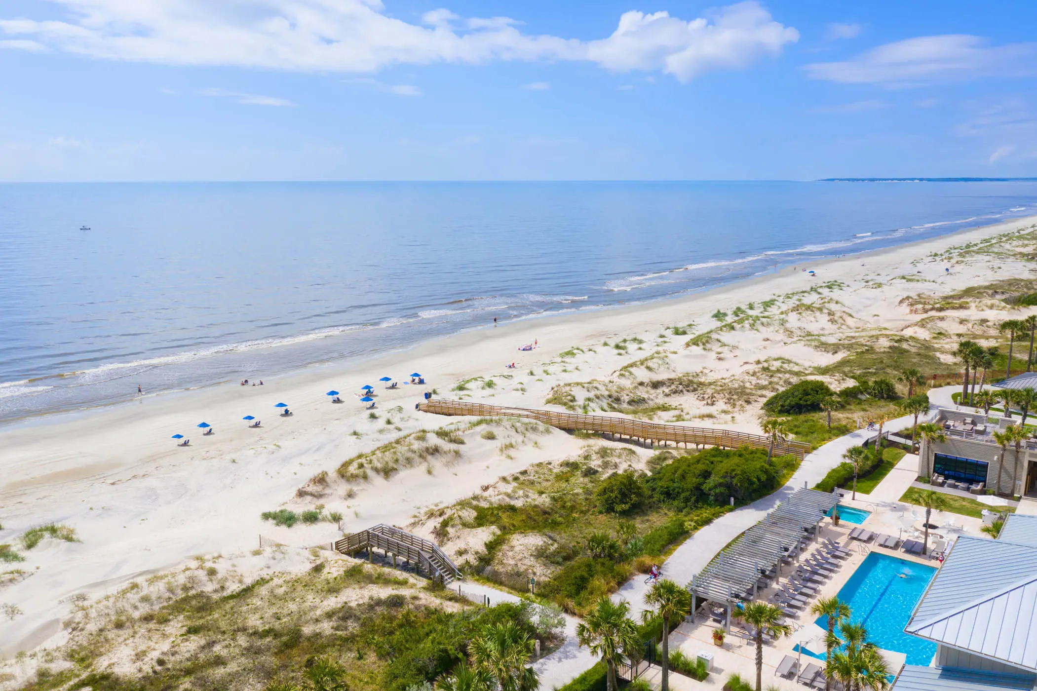 An aerial view of the beach and resort pool