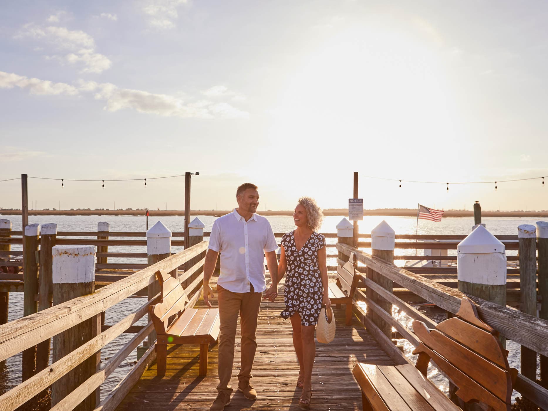 A couple holding hands of the boardwalk