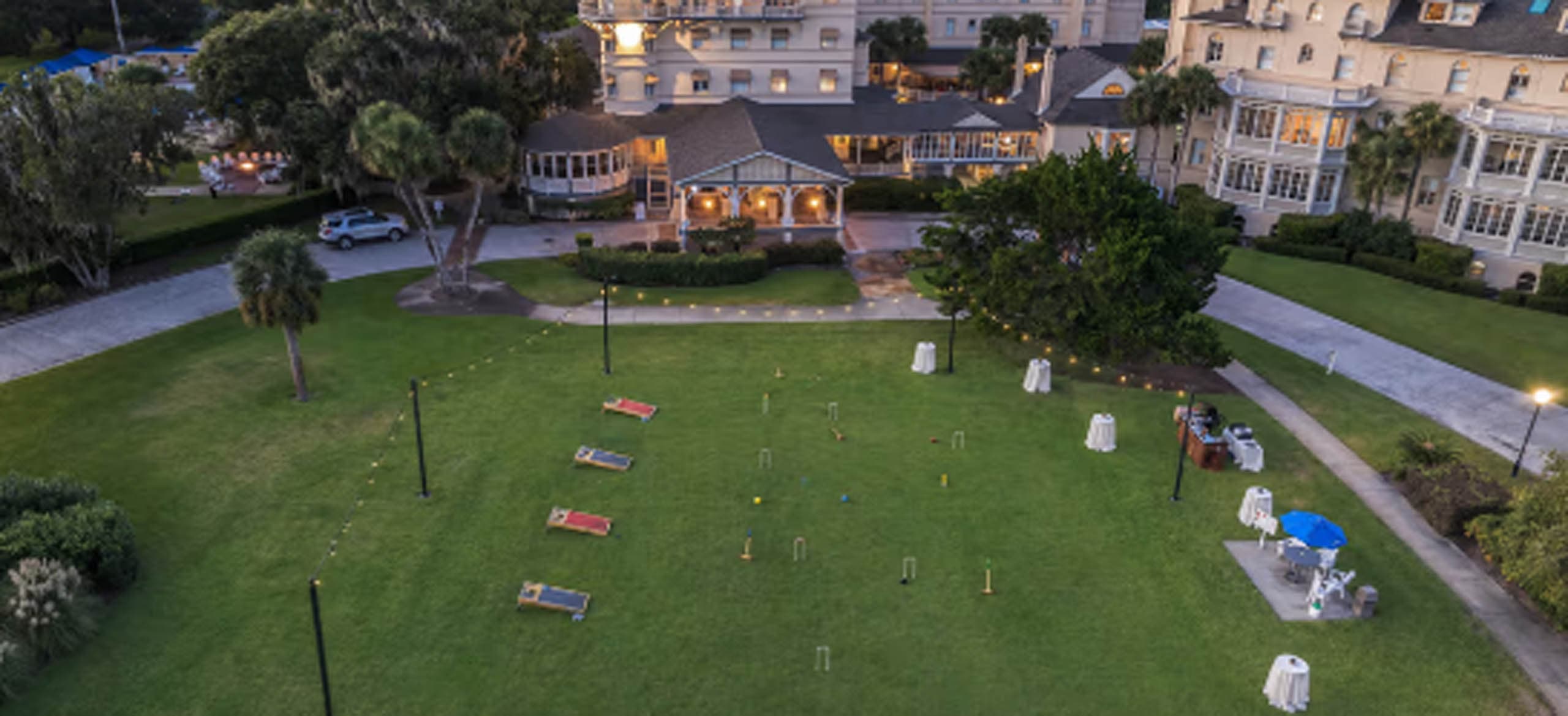 A welcome party out front of Jekyll with corn hole