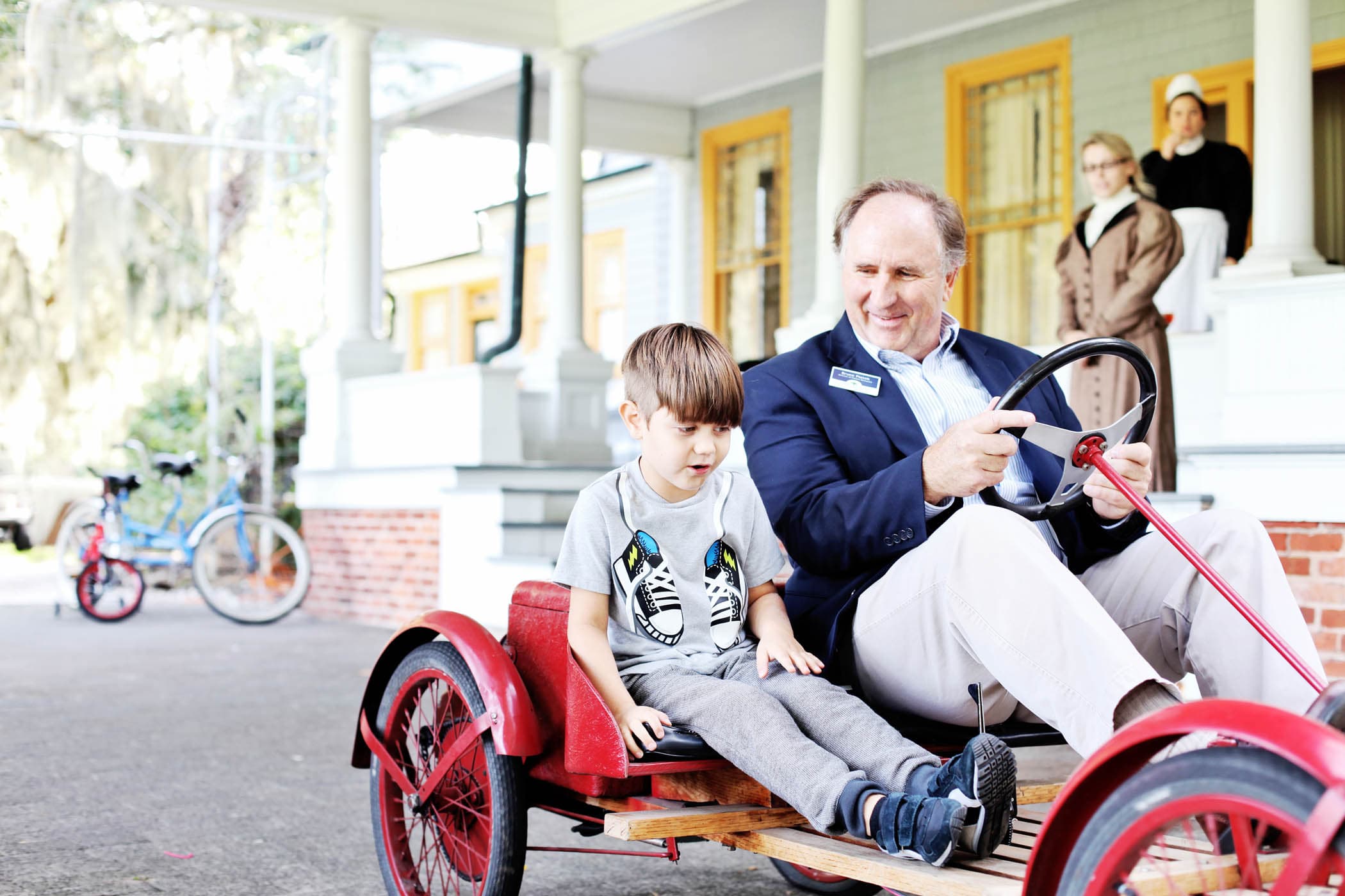 A man and a young child in an old go cart