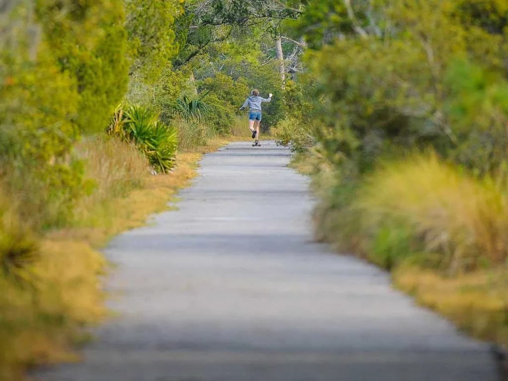 A kid skateboarding on a path