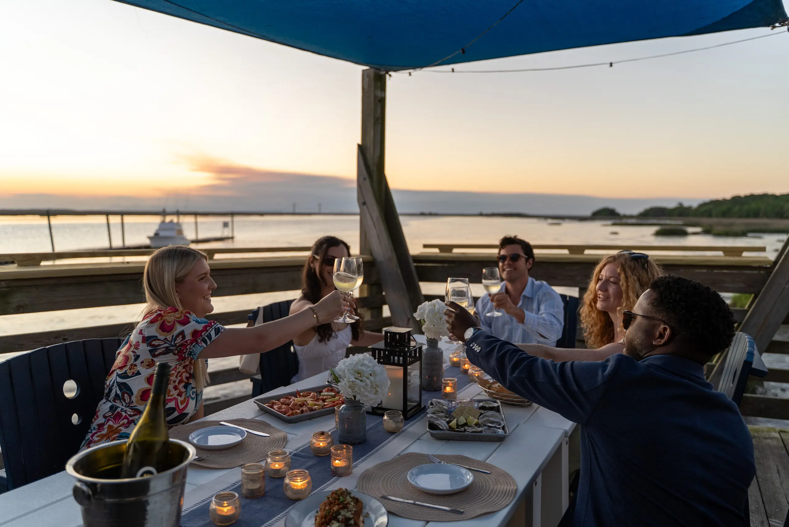People eating and drinking on the Wharf's patio