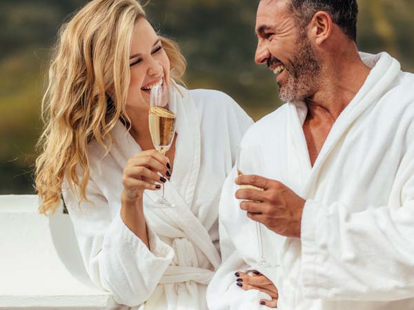 Couple With Champagne And Robes.