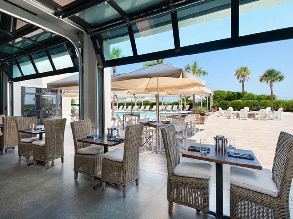 Eighty Ocean Garage Doors Open To The Pool.