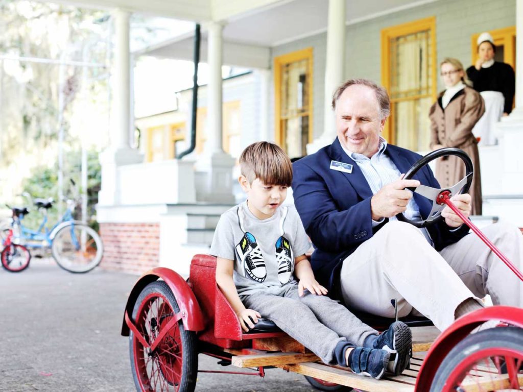 Old Go Cart With Driver And Child.