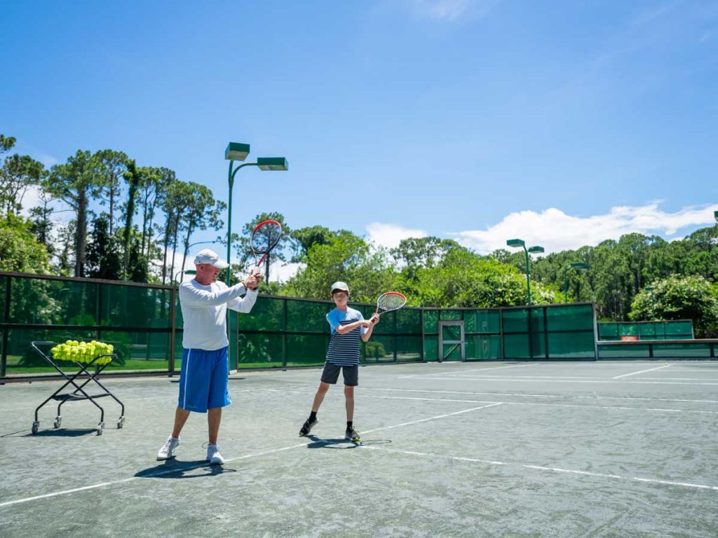 Dad And Son Playing Tennis.