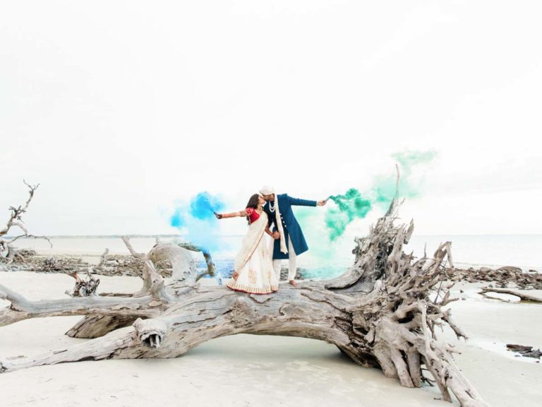 Anvesh And Nehal On A Log By the Beach With Smoke Bombs.