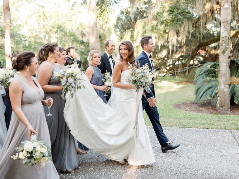 Carolyne And Davis Walking With Their Wedding Party.