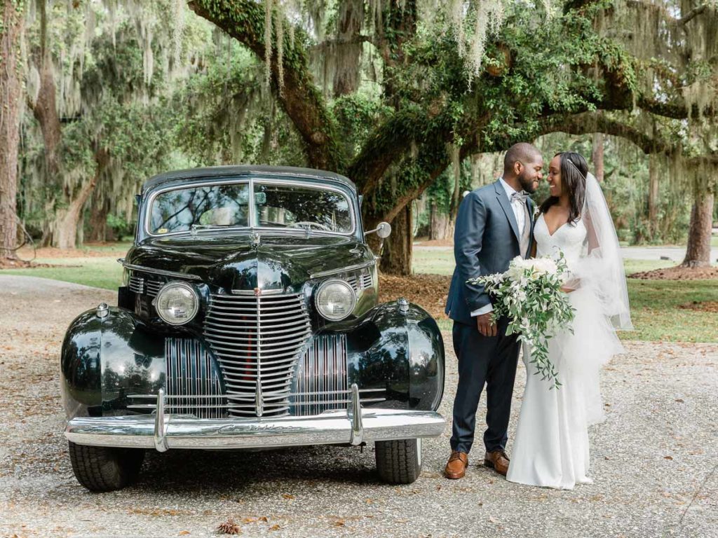 Bride And Groom In Front Of A Car.