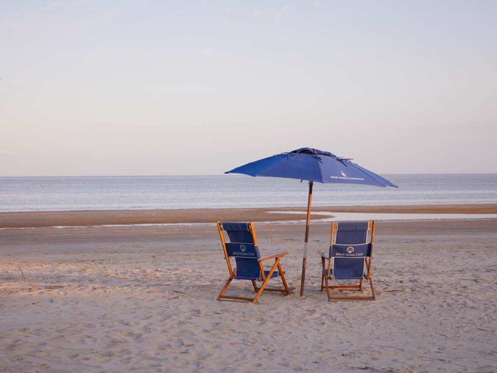 Beach Chairs And Umbrella On The Beach.